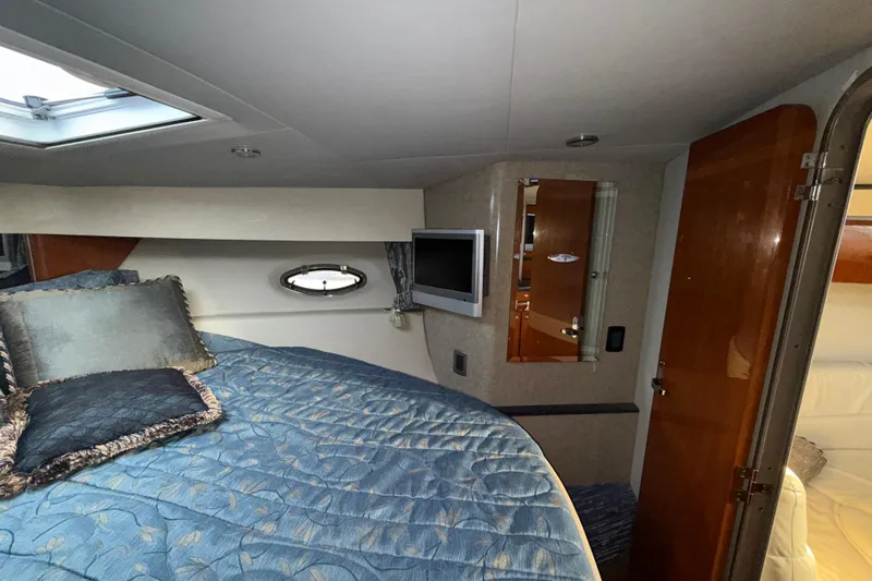  Yacht Photos Pics Interior cabin of 2006 Formula 40 Performance Cruiser with bed, TV, and porthole window.