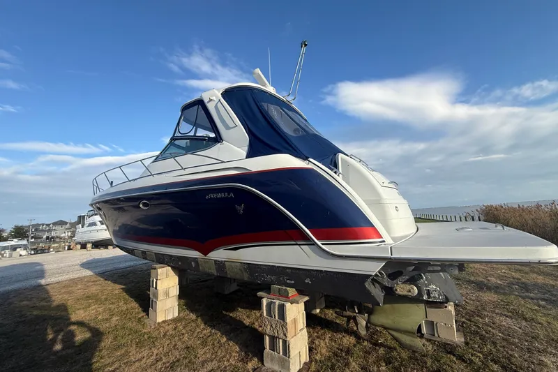  Yacht Photos Pics 2006 Formula 40 Performance Cruiser on blocks, blue and white design, clear sky background.