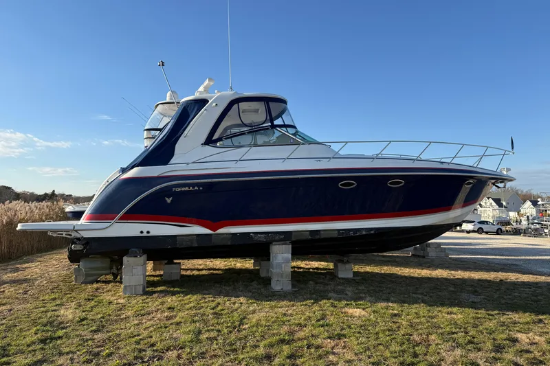  Yacht Photos Pics 2006 Formula 40 Performance Cruiser on blocks, blue and white design, outdoor setting.