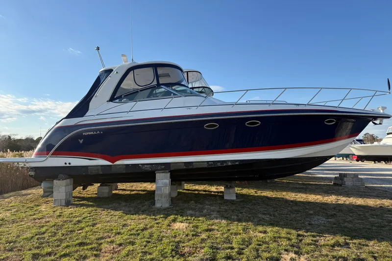  Yacht Photos Pics 2006 Formula 40 Performance Cruiser on blocks, blue and white design, sunny day.