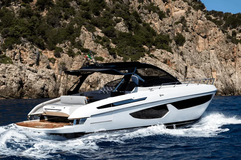  Yacht Photos Pics 2024 FIM 440 Regina yacht cruising near rocky coastline.