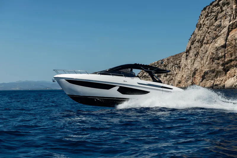  Yacht Photos Pics 2024 FIM 440 Regina yacht cruising near rocky coastline.