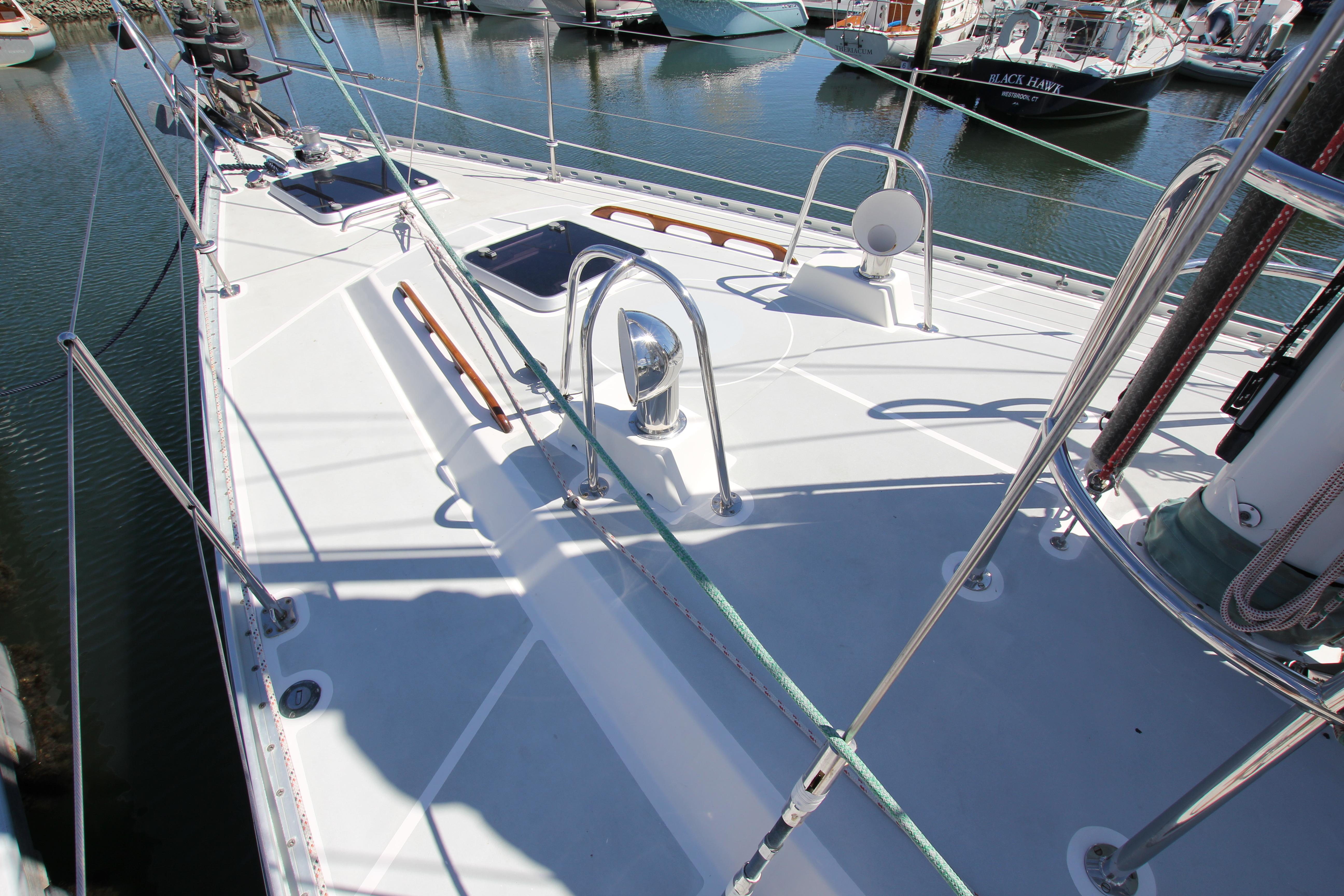 Deck of 1998 Able Apogee 50 sailboat in marina, showcasing sleek design and rigging.