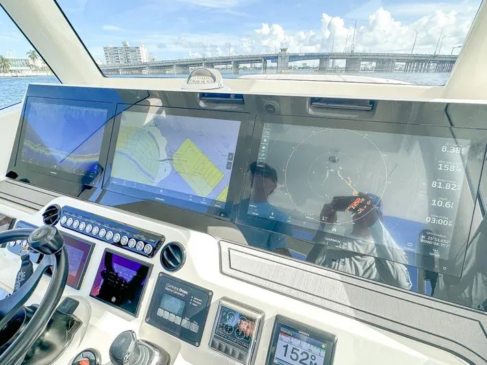 A Salt Weapon Yacht Photos Pics 2022 SeaVee 450z helm with advanced navigation displays and controls.