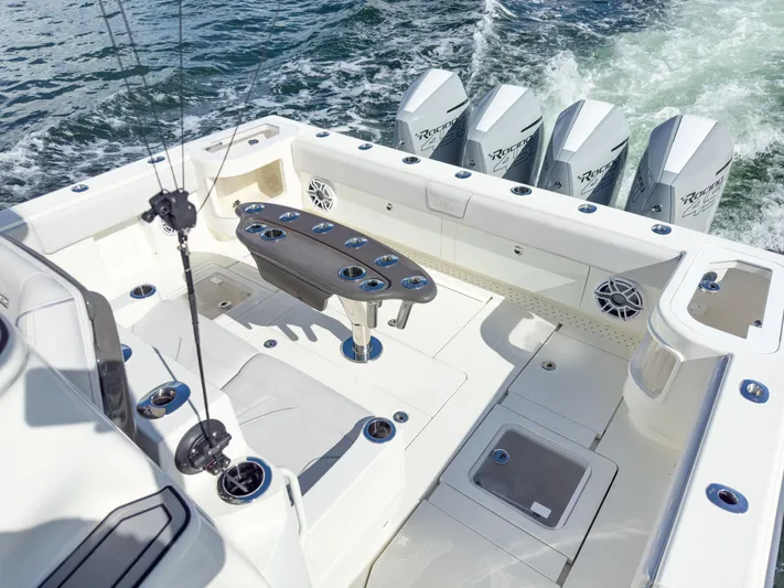 A Salt Weapon Yacht Photos Pics 2022 SeaVee 450z boat with quad engines, spacious deck, and fishing rod holders.