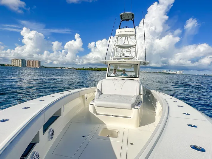A Salt Weapon Yacht Photos Pics 2022 SeaVee 450z boat on open water under a clear blue sky.
