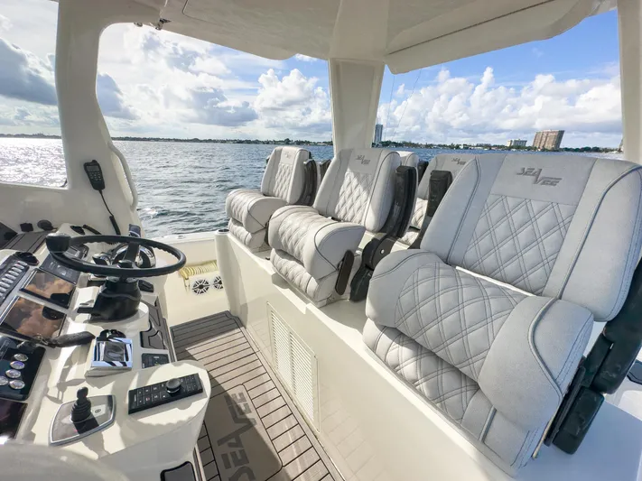 A Salt Weapon Yacht Photos Pics 2022 SeaVee 450z boat interior with luxurious seating and modern controls.
