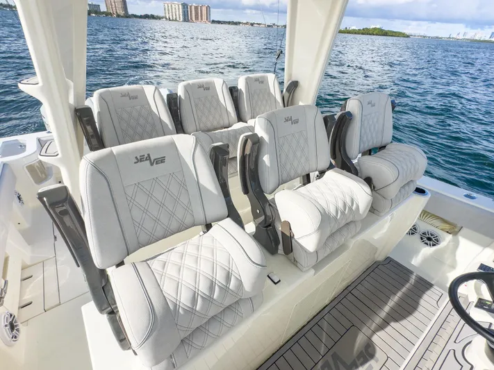 A Salt Weapon Yacht Photos Pics Luxurious seating on 2022 SeaVee 450z boat with ocean backdrop.