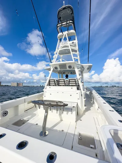 A Salt Weapon Yacht Photos Pics 2022 SeaVee 450z boat with tower, on open water under blue sky.