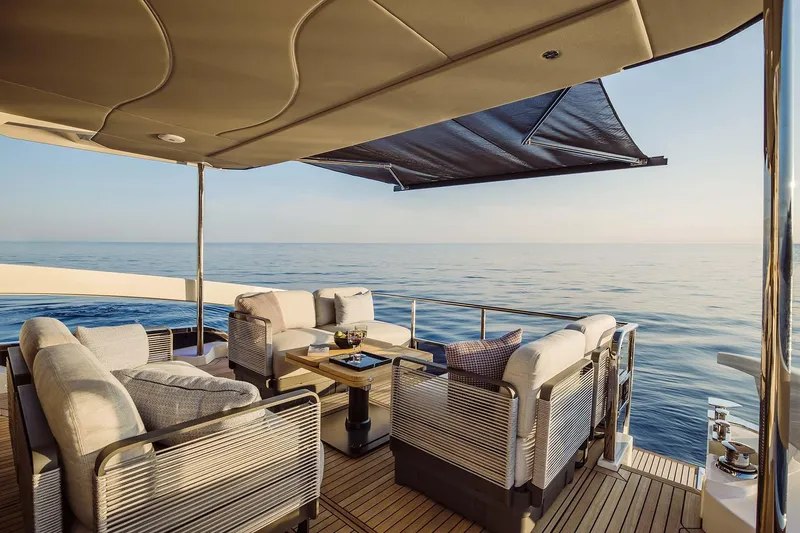 Yacht Photos Pics Luxurious 2025 Absolute 52 FLY yacht deck with elegant seating and ocean view.