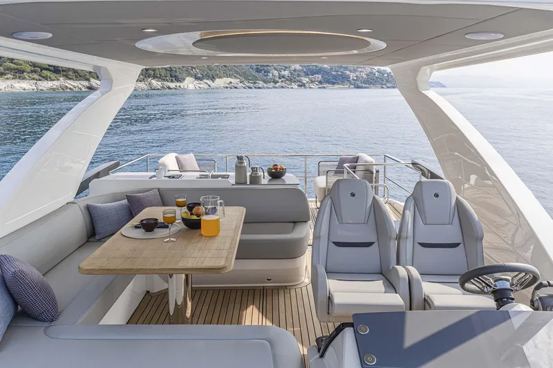  Yacht Photos Pics Luxurious 2025 Absolute 52 FLY yacht interior with dining area and ocean view.