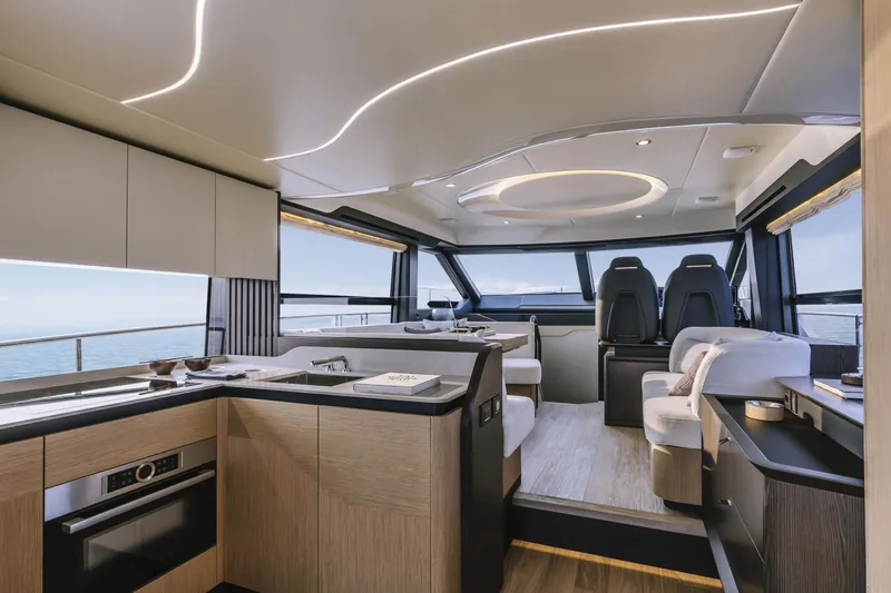  Yacht Photos Pics Luxurious interior of 2025 Absolute 52 FLY yacht with modern kitchen and seating area.