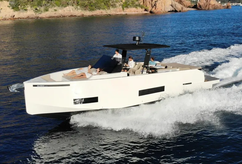  Yacht Photos Pics 2026 De Antonio Yachts D42 cruising on open water with passengers enjoying the ride.