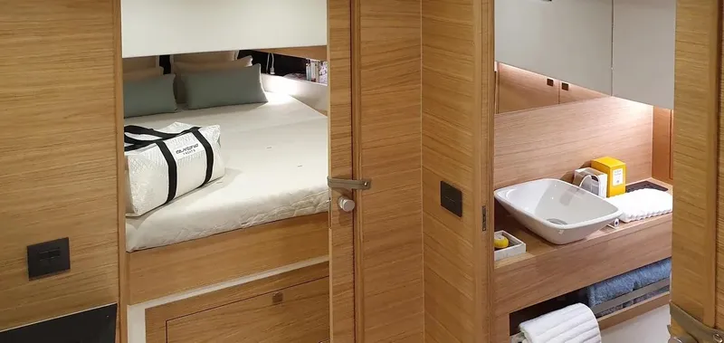  Yacht Photos Pics Luxurious interior of 2026 De Antonio Yachts D42, featuring a cozy bedroom and modern bathroom.