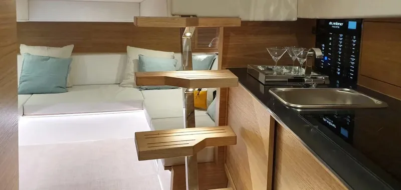 Yacht Photos Pics Interior of 2026 De Antonio Yachts D42, featuring modern kitchen and cozy seating area.
