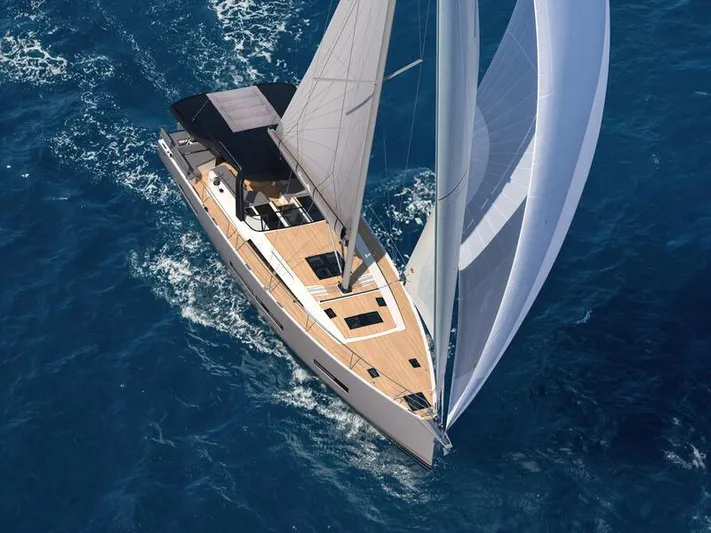  Yacht Photos Pics Aerial view of 2026 Hanse 590 yacht sailing on blue ocean waters.