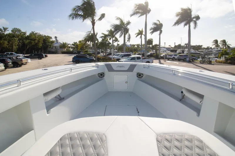  Yacht Photos Pics 2026 Invincible 39 Open Fisherman boat interior with palm trees and parked cars in the background.