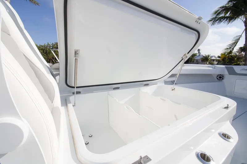  Yacht Photos Pics Open storage compartment on 2026 Invincible 39 Open Fisherman boat, under clear blue sky.