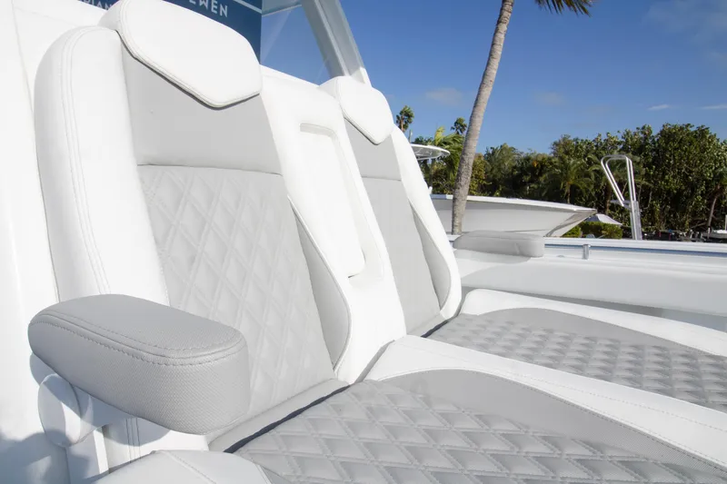 Yacht Photos Pics Luxurious seating on 2026 Invincible 39 Open Fisherman boat, featuring elegant white and gray upholstery.