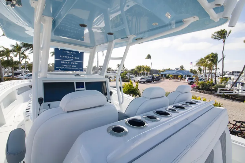  Yacht Photos Pics 2026 Invincible 39 Open Fisherman boat interior with helm and seating, dockside view.