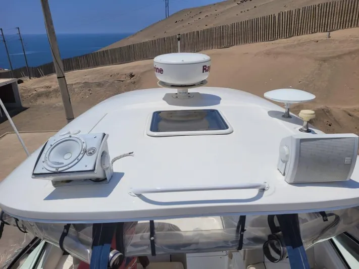 Knot On Call Yacht Photos Pics Sea Ray Sundancer 370 (2013) boat deck with radar, speakers, and ocean view.