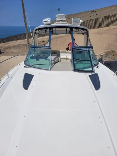 Knot On Call Yacht Photos Pics 2013 Sea Ray Sundancer 370 yacht on sandy shore with clear blue sky.