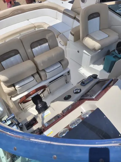 Knot On Call Yacht Photos Pics 2013 Sea Ray Sundancer 370 cockpit with beige seating and control panel.