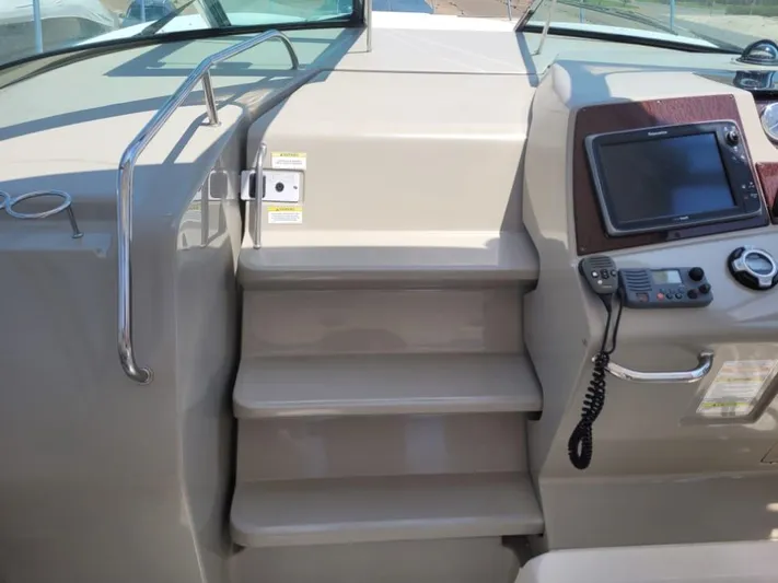 Knot On Call Yacht Photos Pics 2013 Sea Ray Sundancer 370 helm with steps, navigation screen, and control panel.