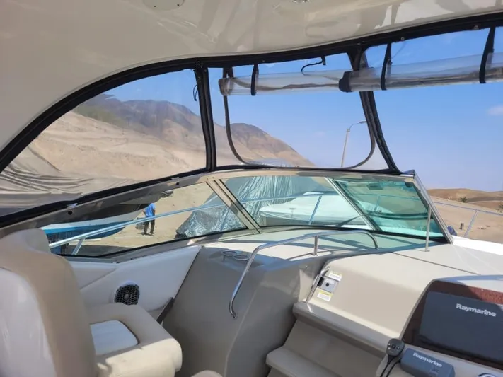 Knot On Call Yacht Photos Pics Interior view of 2013 Sea Ray Sundancer 370 yacht cockpit with scenic outdoor backdrop.