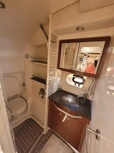 Knot On Call Yacht Photos Pics 2013 Sea Ray Sundancer 370 bathroom with sink, mirror, and toilet in compact, elegant design.