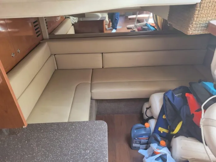 Knot On Call Yacht Photos Pics Interior of 2013 Sea Ray Sundancer 370 with beige seating and storage items.