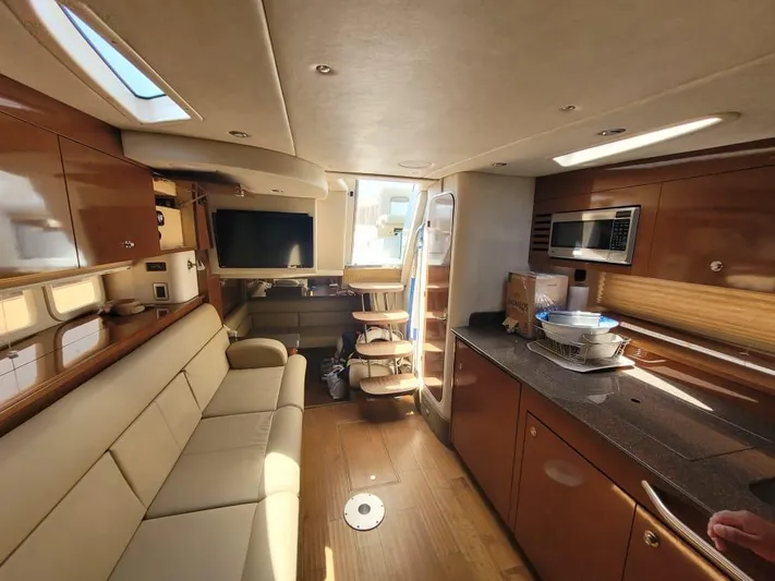 Knot On Call Yacht Photos Pics Interior of 2013 Sea Ray Sundancer 370 yacht, featuring a cozy lounge and modern kitchen amenities.