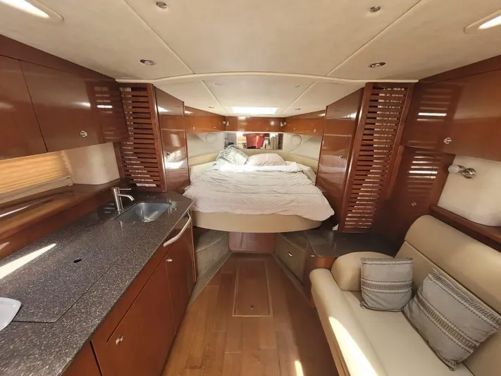 Knot On Call Yacht Photos Pics Luxurious interior of 2013 Sea Ray Sundancer 370 yacht with cozy bed and kitchenette.