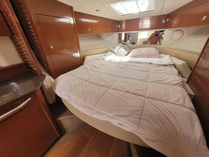 Knot On Call Yacht Photos Pics Luxurious cabin interior of 2013 Sea Ray Sundancer 370 with cozy bed and wooden finishes.
