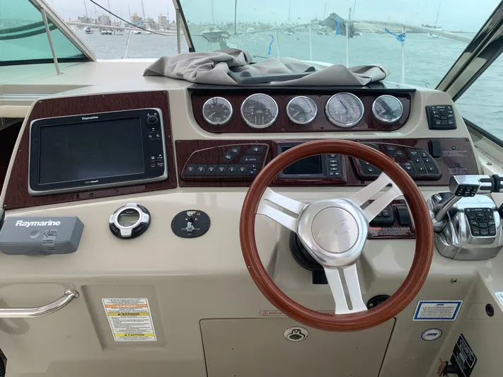 Knot On Call Yacht Photos Pics 2013 Sea Ray Sundancer 370 helm with steering wheel, gauges, and navigation equipment.
