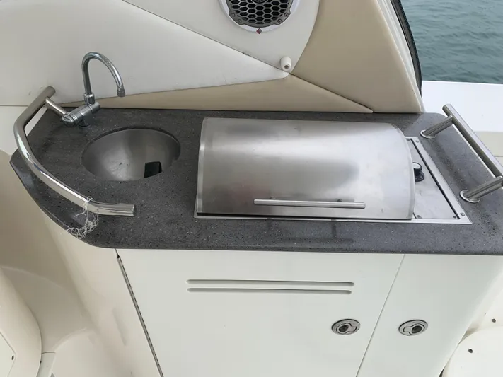 Knot On Call Yacht Photos Pics Outdoor kitchenette on 2013 Sea Ray Sundancer 370 yacht with sink and grill.