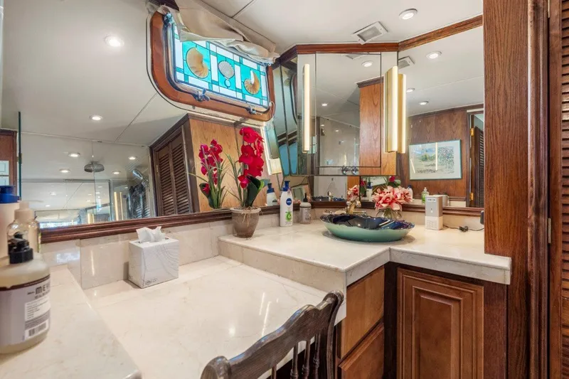 Envision Yacht Photos Pics Luxurious 1984 Broward 110 Motor Yacht interior with elegant vanity and stained glass window.