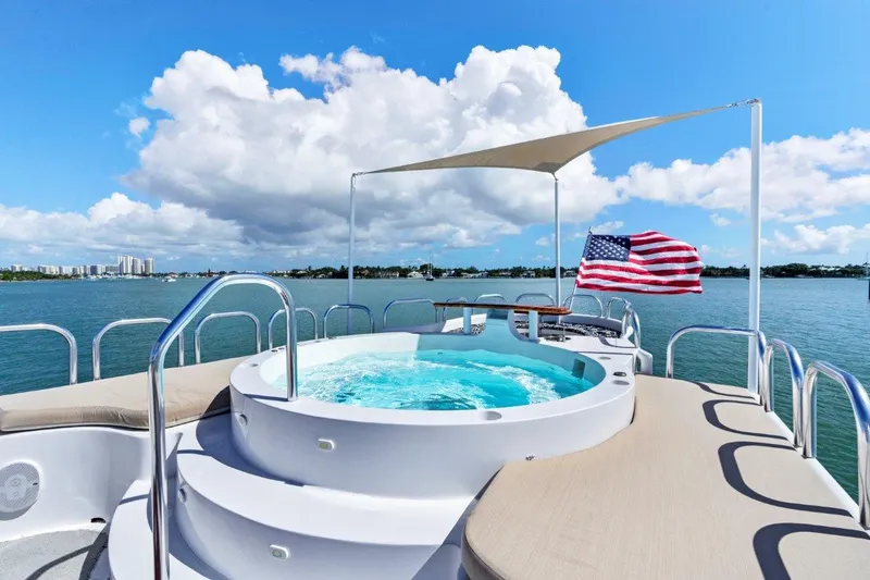 Envision Yacht Photos Pics Broward 110 Motor Yacht 1984 with jacuzzi and American flag on deck.