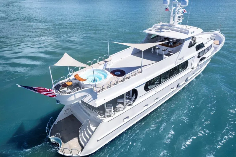 Envision Yacht Photos Pics Luxurious 1984 Broward 110 Motor Yacht cruising on clear blue waters.