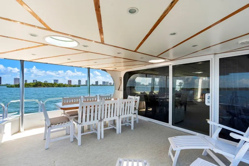 Envision Yacht Photos Pics Spacious deck of 1984 Broward 110 Motor Yacht with ocean view and seating area.