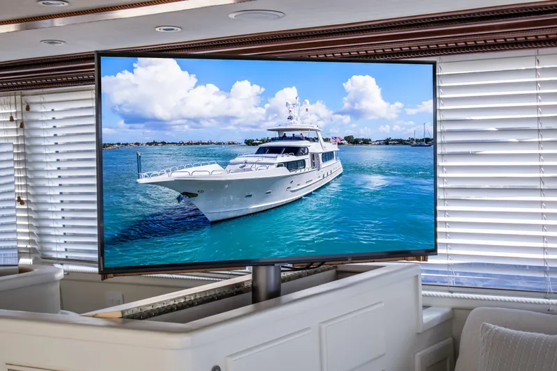 Envision Yacht Photos Pics Broward 110 Motor Yacht 1984 displayed on a TV in a luxurious room.