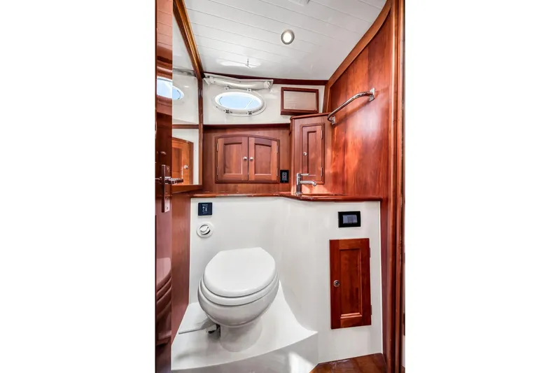 Wren Yacht Photos Pics Luxurious 2015 Hinckley Talaria 43 Motoryacht bathroom with elegant wood cabinetry and modern fixtures.