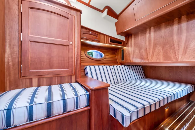 Wren Yacht Photos Pics Interior of 2015 Hinckley Talaria 43 Motoryacht with striped seating and wooden cabinetry.