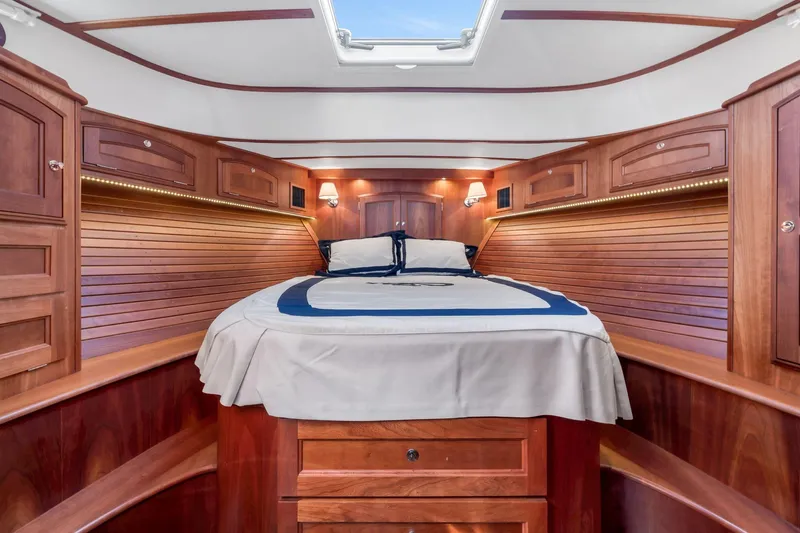 Wren Yacht Photos Pics Luxurious 2015 Hinckley Talaria 43 Motoryacht cabin with elegant wood finish and cozy bedding.