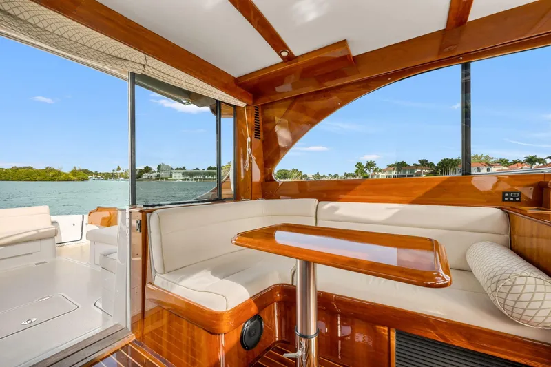 Wren Yacht Photos Pics Luxurious interior of 2015 Hinckley Talaria 43 Motoryacht with elegant wood finish and waterfront view.