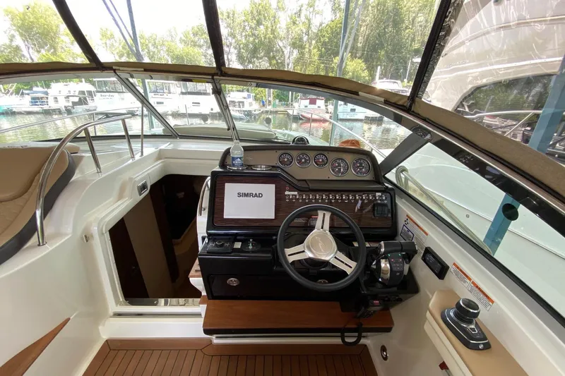  Yacht Photos Pics 2018 Sea Ray Sundancer 350 helm with Simrad display, steering wheel, and control panel.