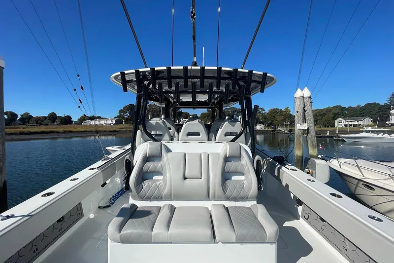  Yacht Photos Pics 2024 Freeman 42LR boat with luxurious seating, docked by a serene waterfront.