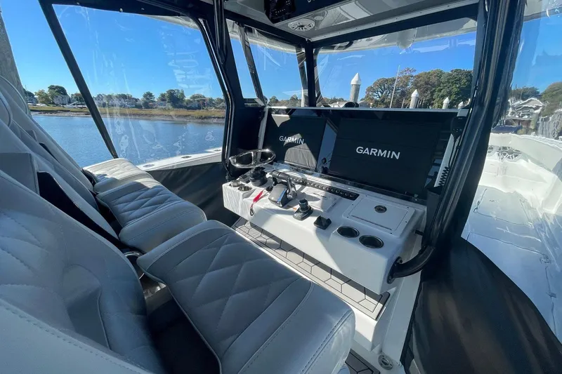  Yacht Photos Pics Interior of 2024 Freeman 42LR boat with Garmin navigation system and luxurious seating.