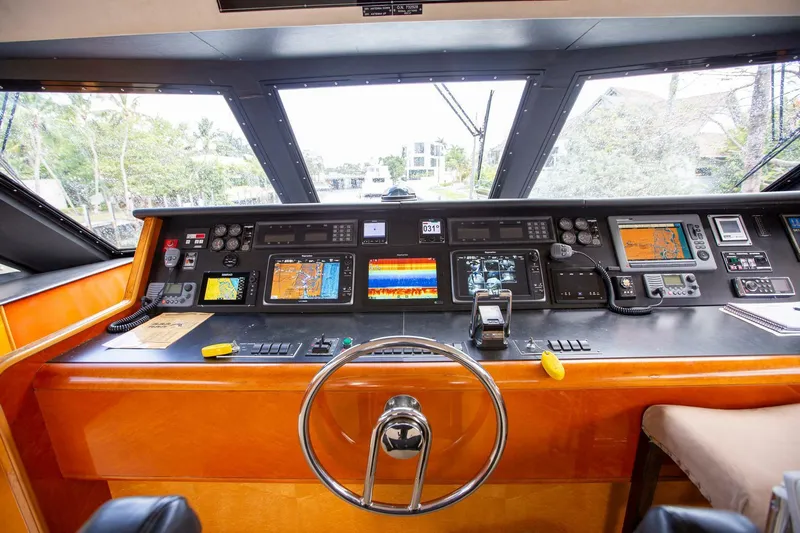 Painkiller Yacht Photos Pics Control panel of a 1999 Tarrab Motor Yacht with navigation instruments and steering wheel.
