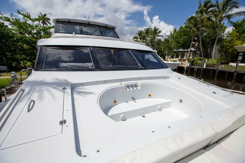 Painkiller Yacht Photos Pics Tarrab 1999 motor yacht with spacious deck and jacuzzi, surrounded by tropical scenery.